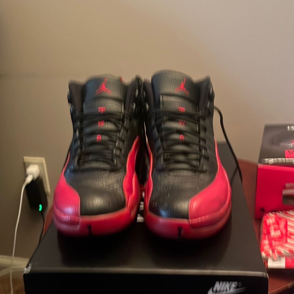Red and black retro 12 air Jordans. Previously used and kept in good condition.